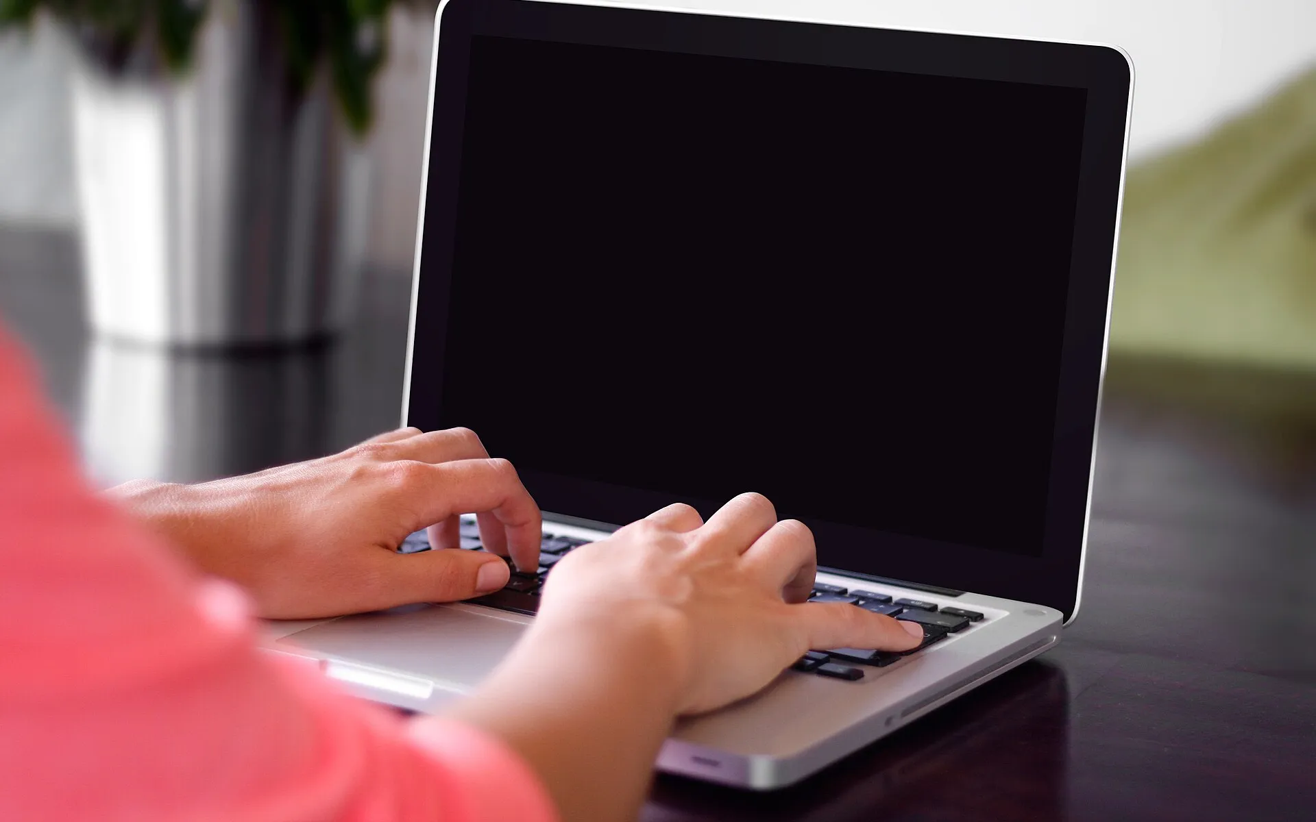 Typing on a laptop