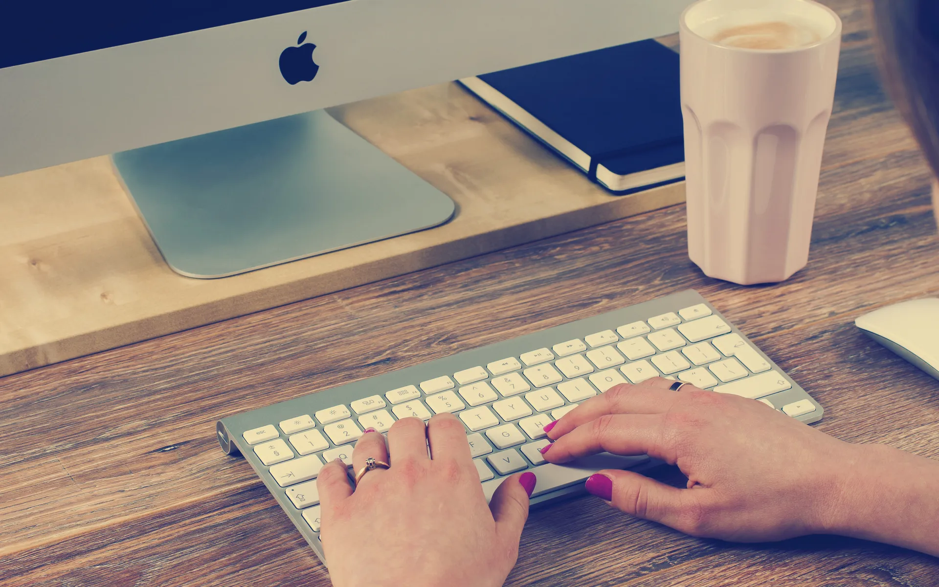 Woman typing at a computer