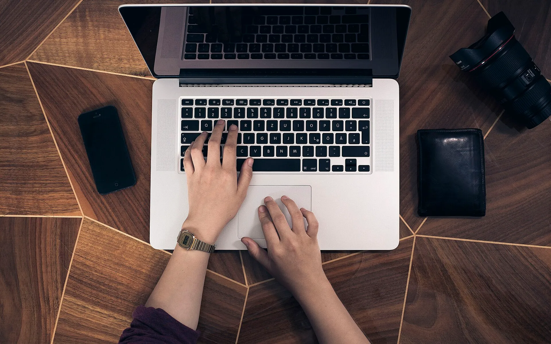 Hands on a laptop keyboard