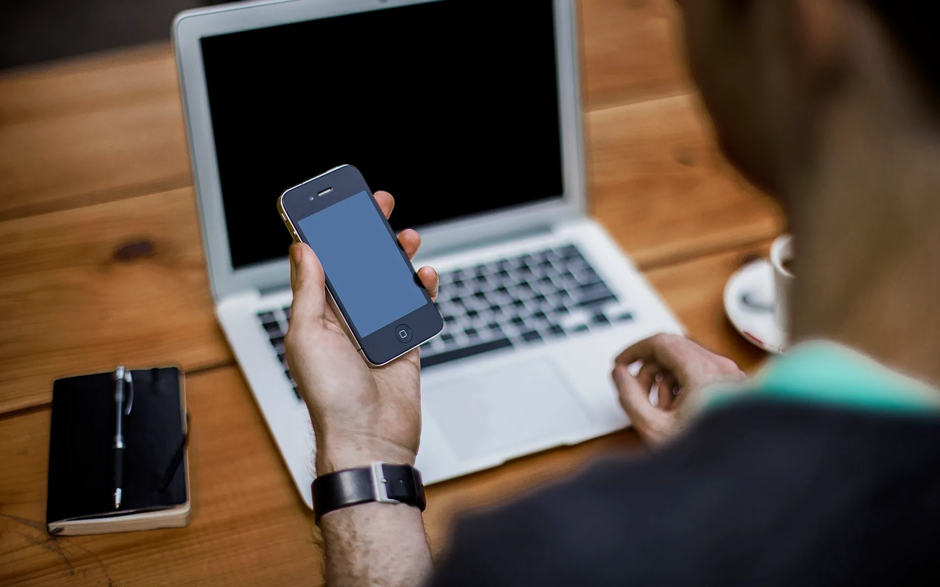 Man with smartphone and laptop