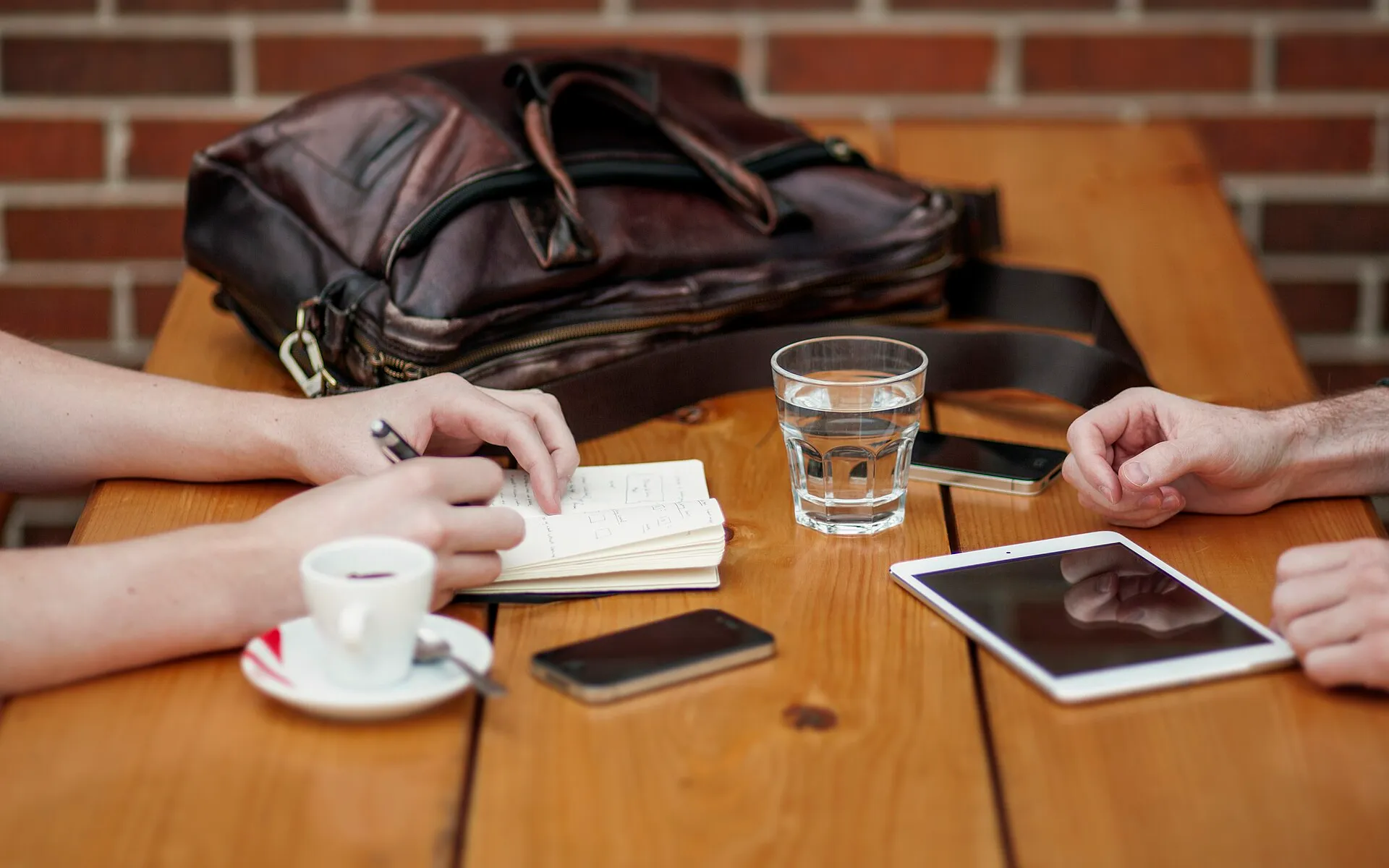 Two people meeting with iphone and ipad