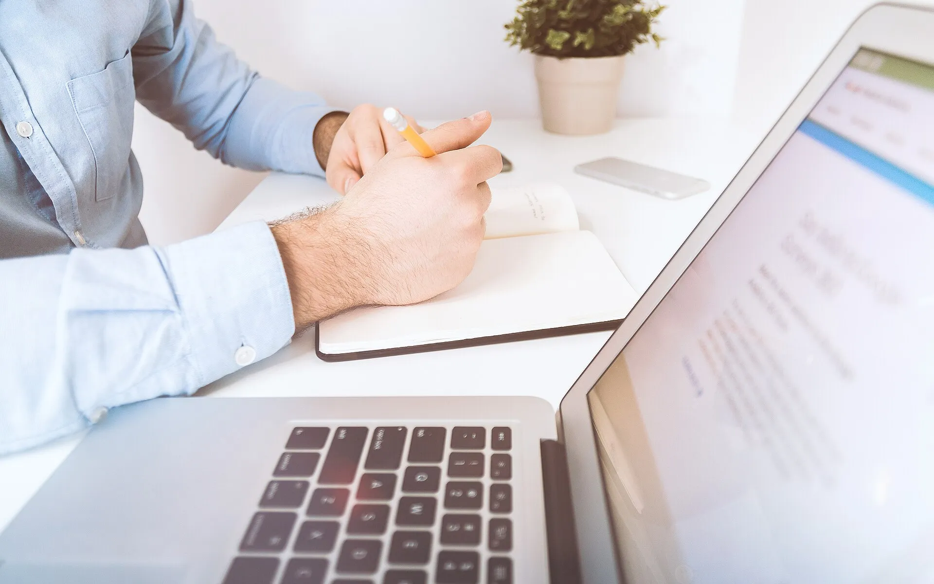 Businessman working and writing notes in office